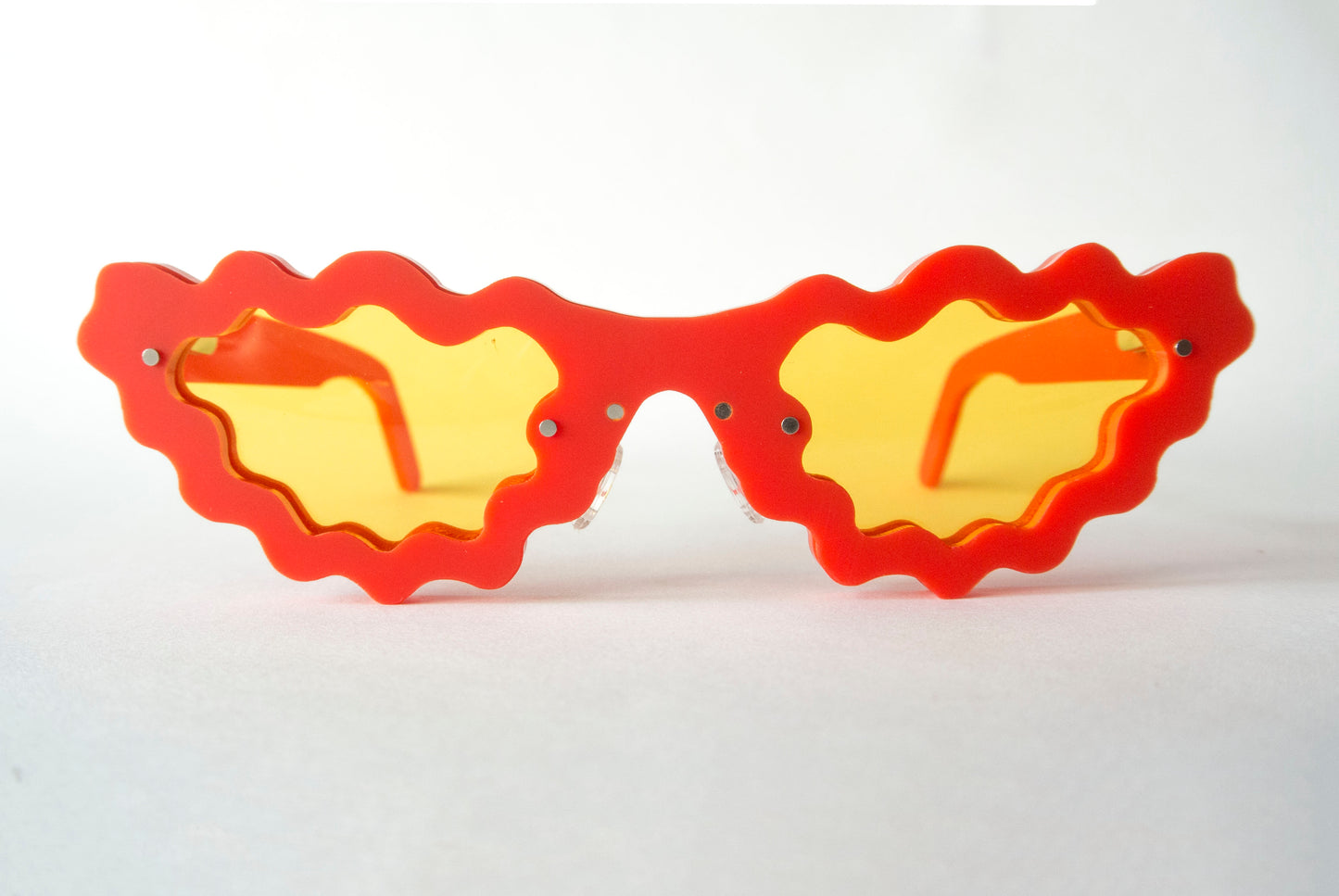 red and yellow sunglasses in a unique wavy style