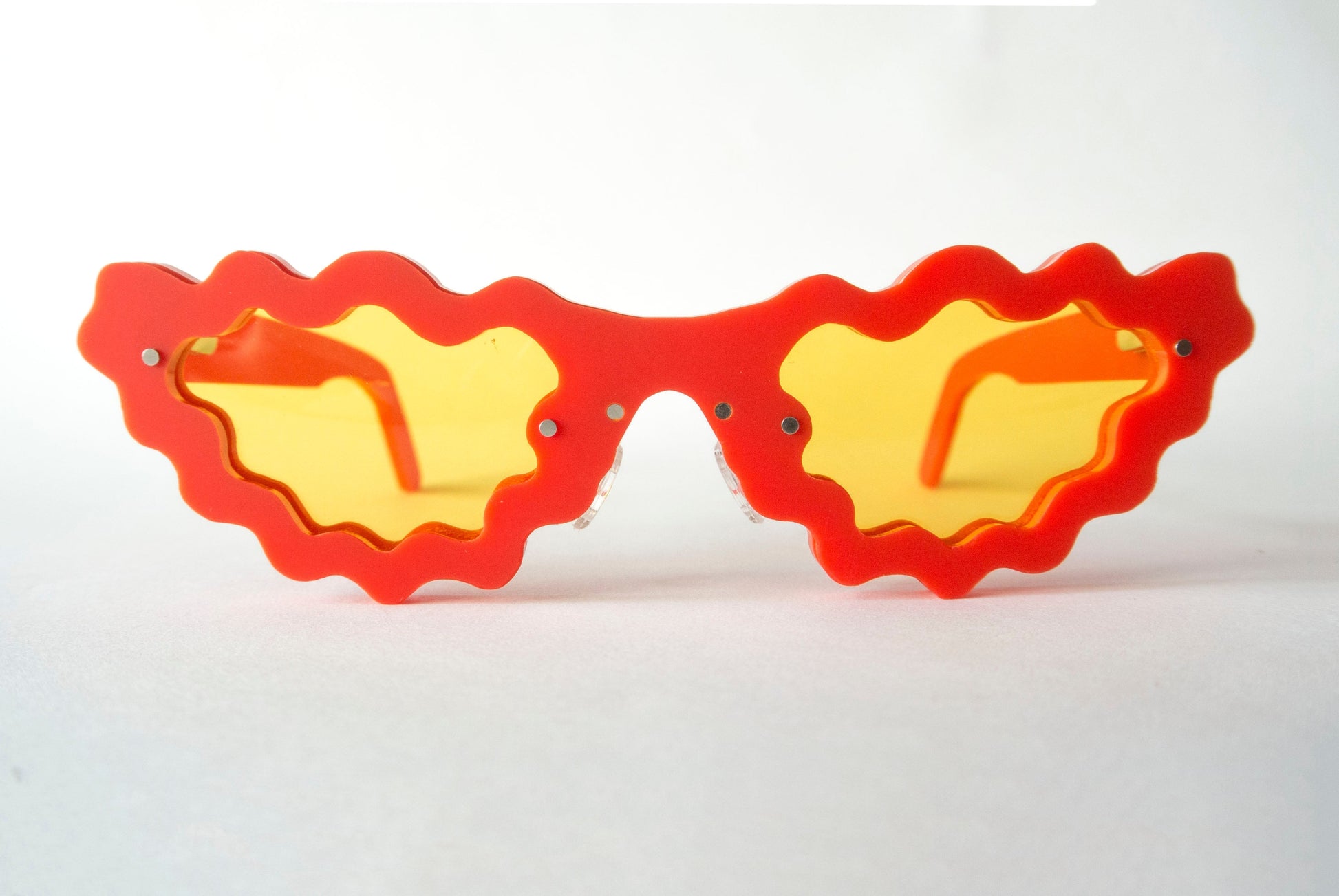 red and yellow sunglasses in a unique wavy style