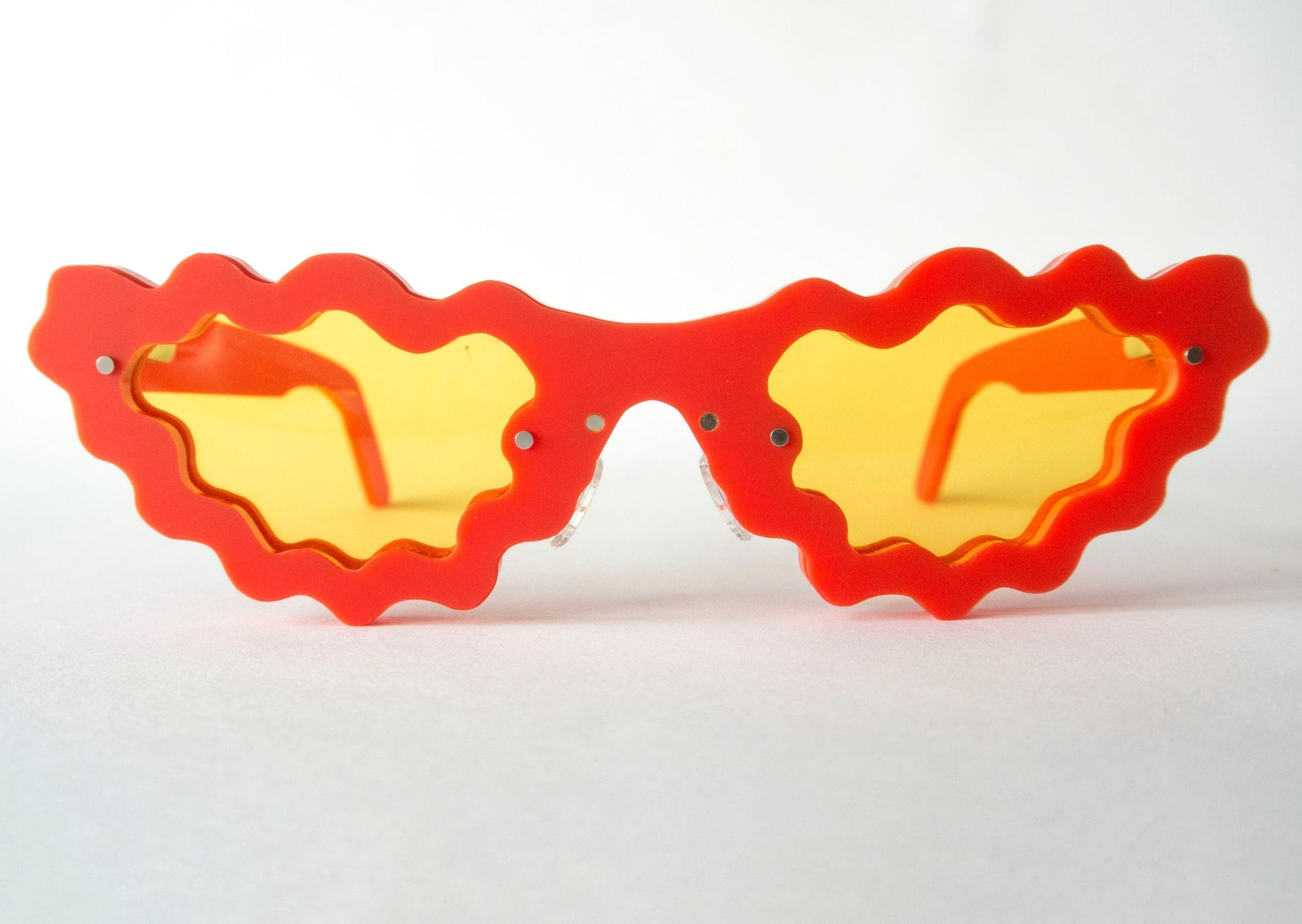 red and yellow sunglasses in a unique wavy style