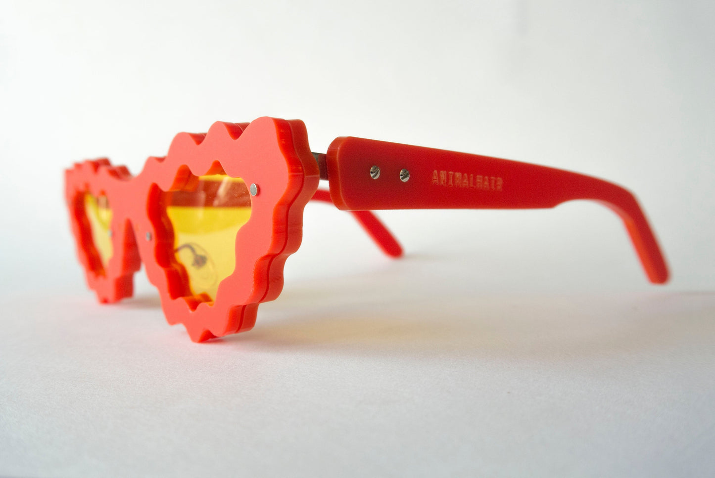 Red avant garde glasses with yellow lenses