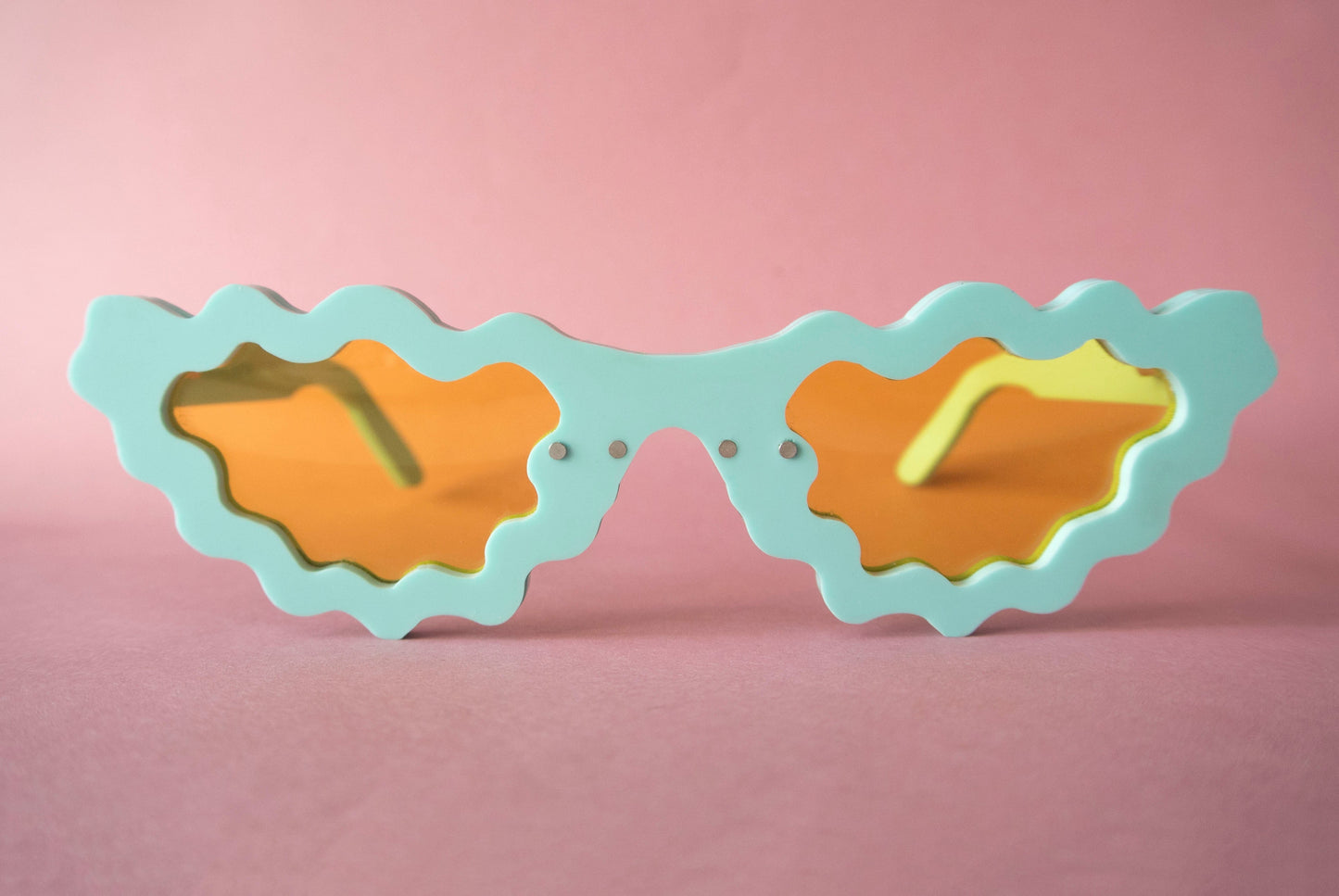 Spearmint librarian glasses on a pink background