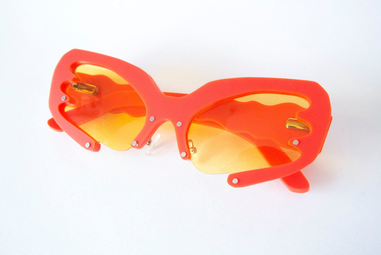 Red frame sunglasses with yellow lenses in Y2K style by Anna Mulhearn
