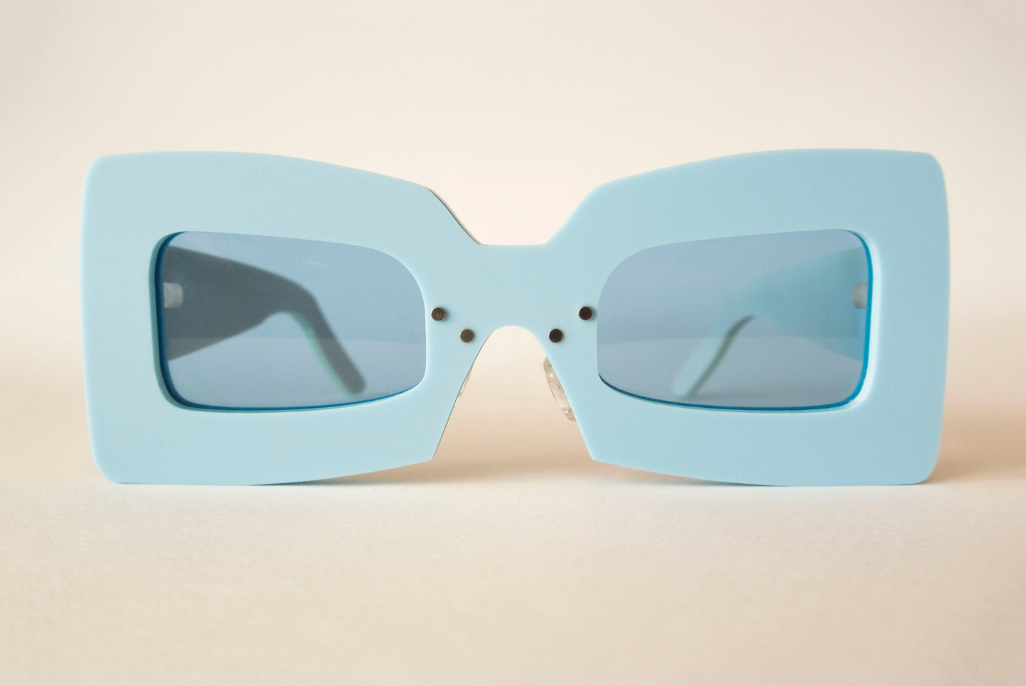 light blue statement sunglasses with blue lenses in square shape