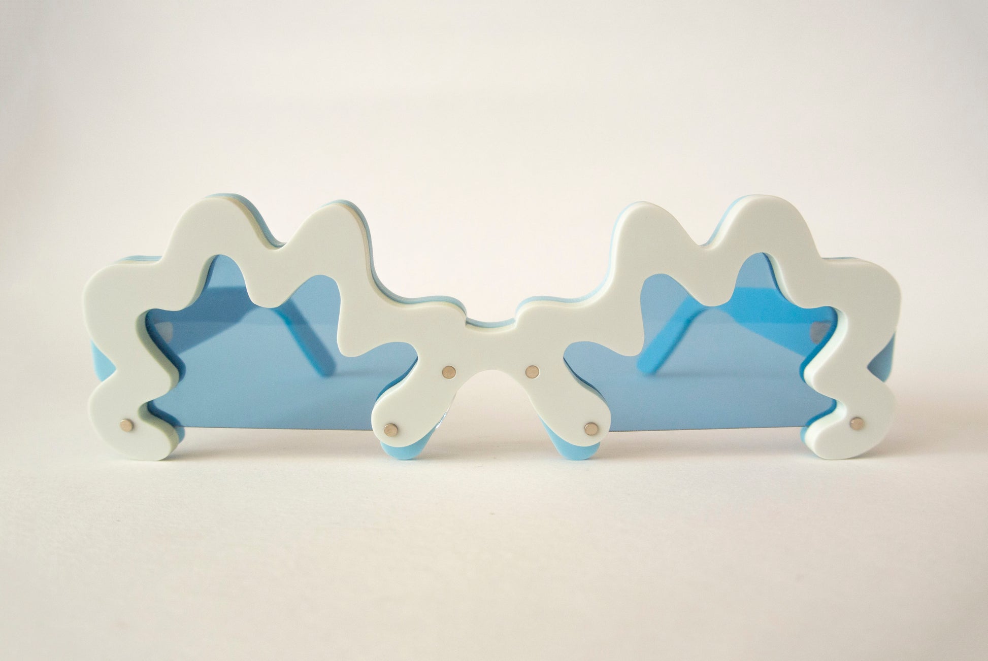 blue rim glasses with blue lenses in an irregular shape