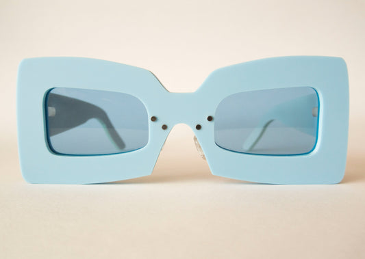 light blue statement sunglasses with blue lenses in square shape