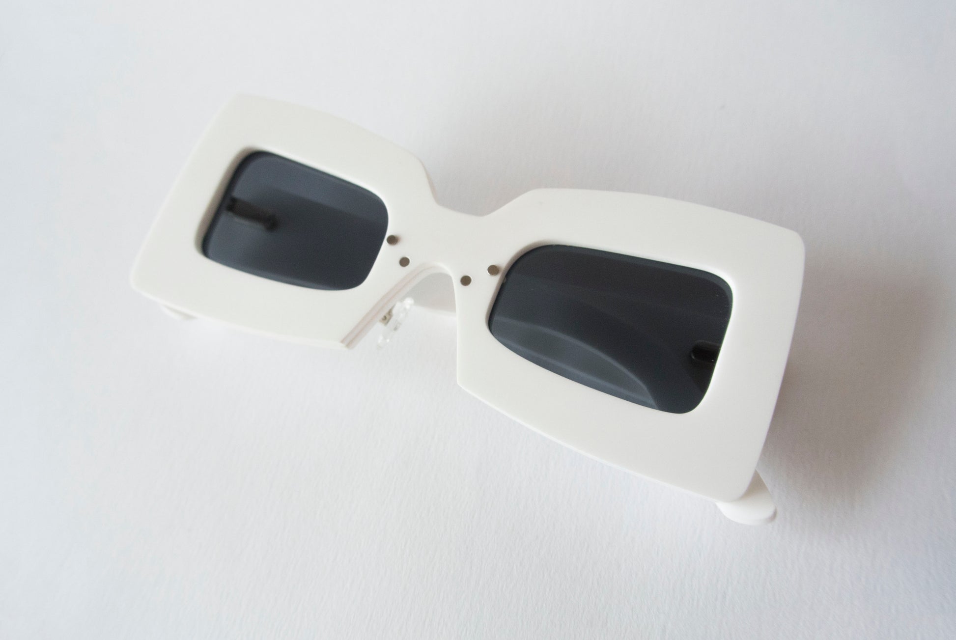 white and black sunglasses in a squared off shape