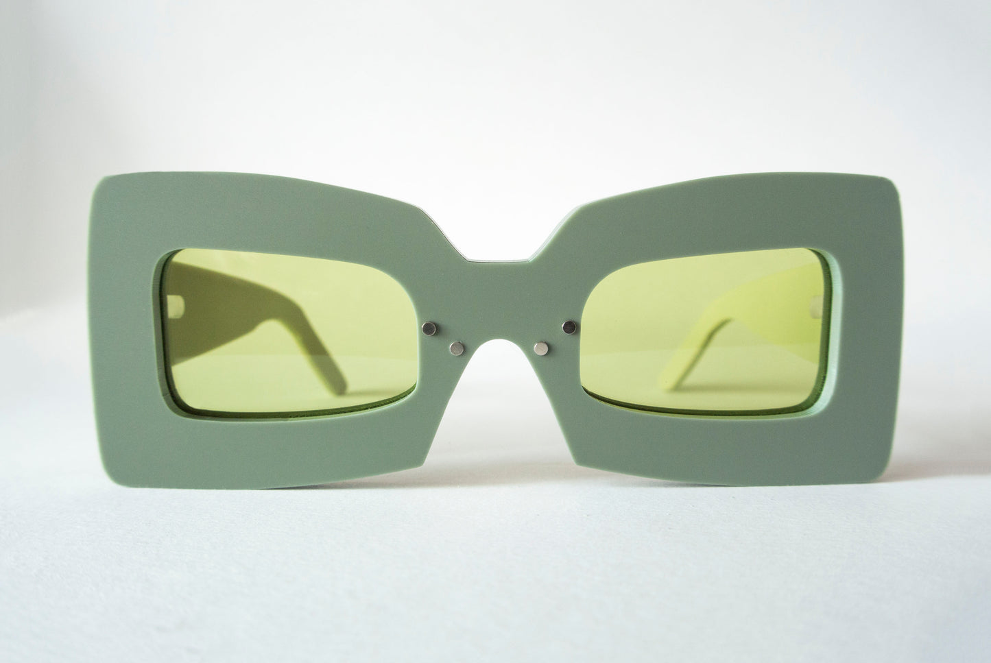 khaki color square shaped glasses with green lenses