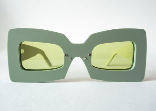 khaki color square shaped glasses with green lenses
