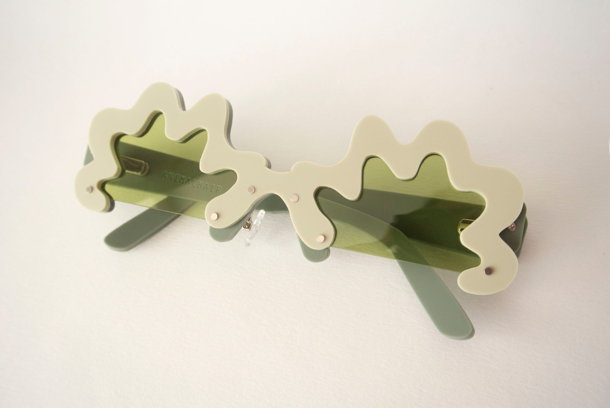 green sunglasses with green lenses in an avant garde style