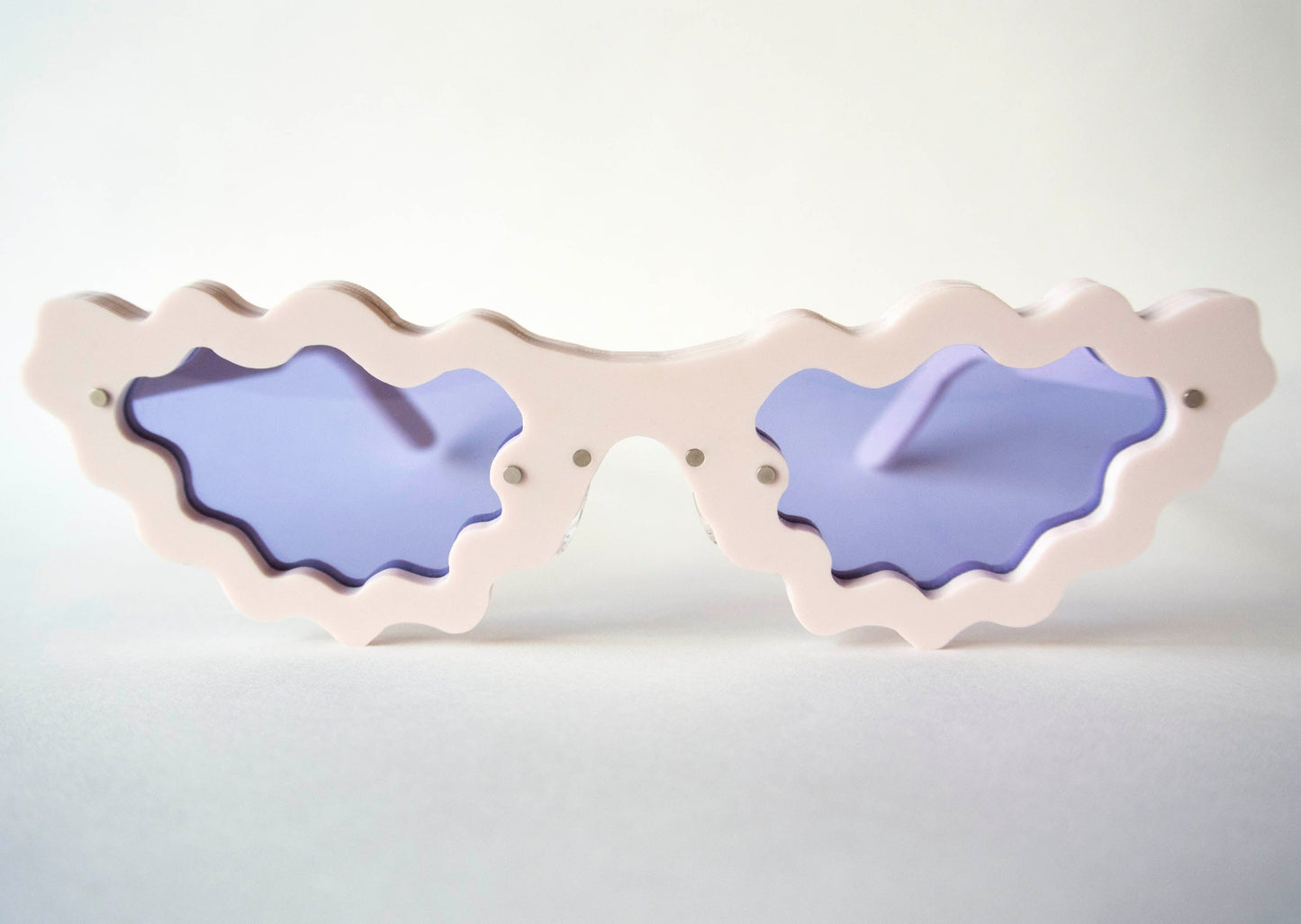 marshmallow frame colour sunglasses with violet lenses and wiggly detail 