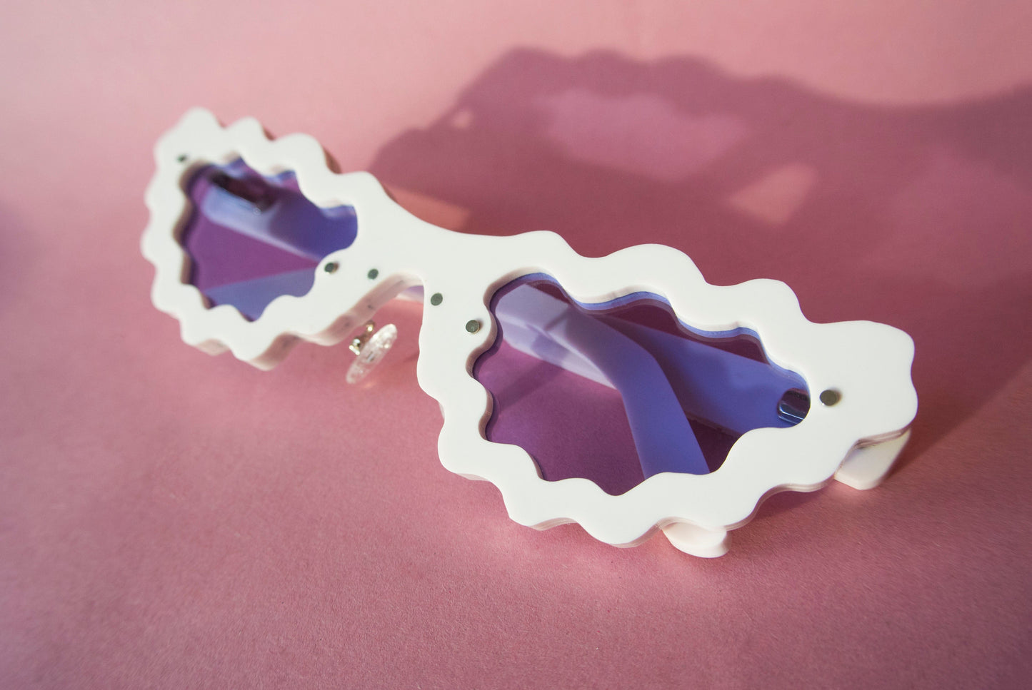 light pink sunglasses with violet lenses