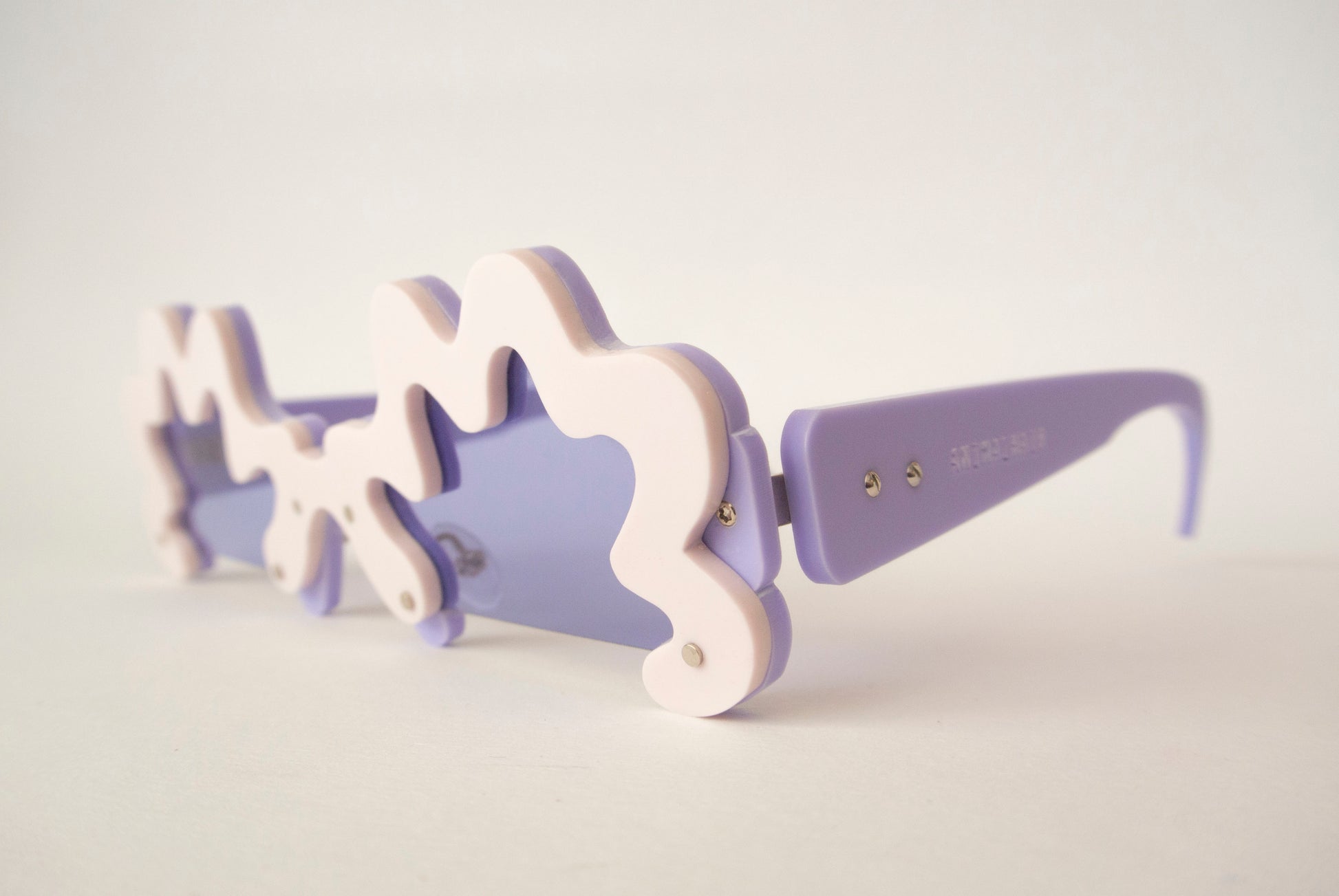 unusual shaped sunglasses in lilac with violet lenses