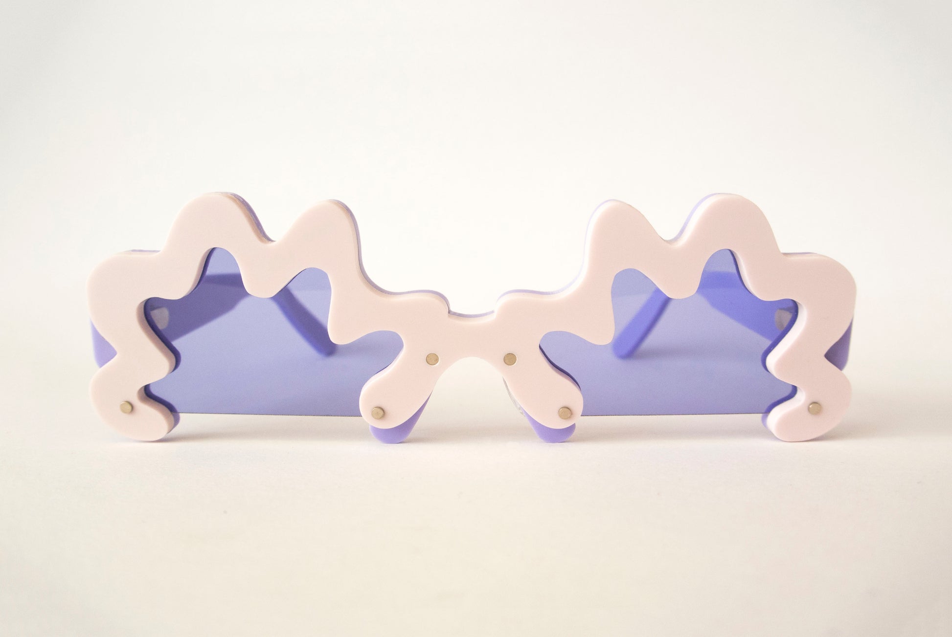 violet purple lensed glasses with light pink wobbly rims by sunglasses designer anna mulhearn