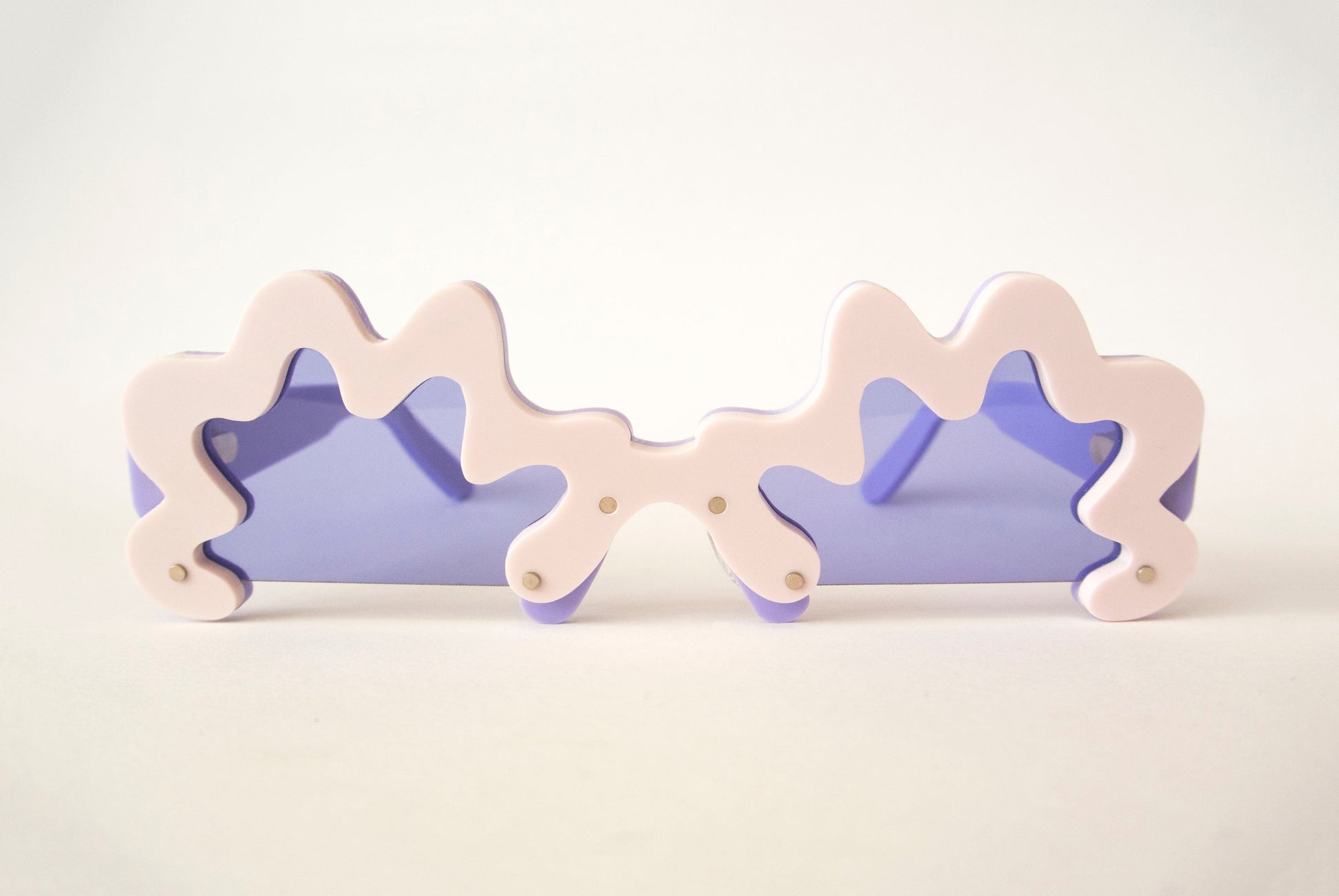 violet purple lensed glasses with light pink wobbly rims by sunglasses designer anna mulhearn