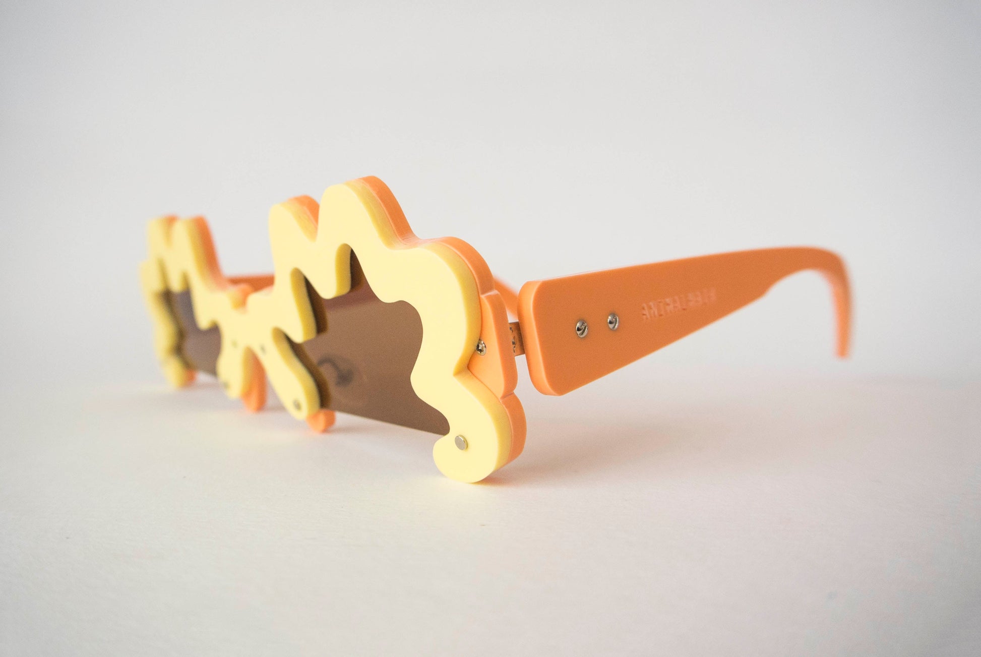 side view of wriggle glasses by animalhair in orange and yellow