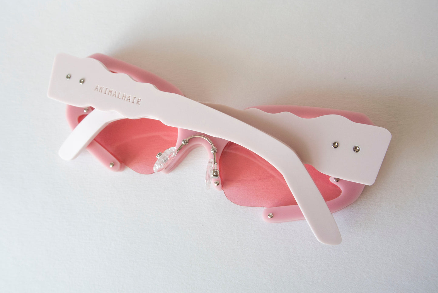 back view of pink glasses with light pink irregular shaped temples by anialhair.