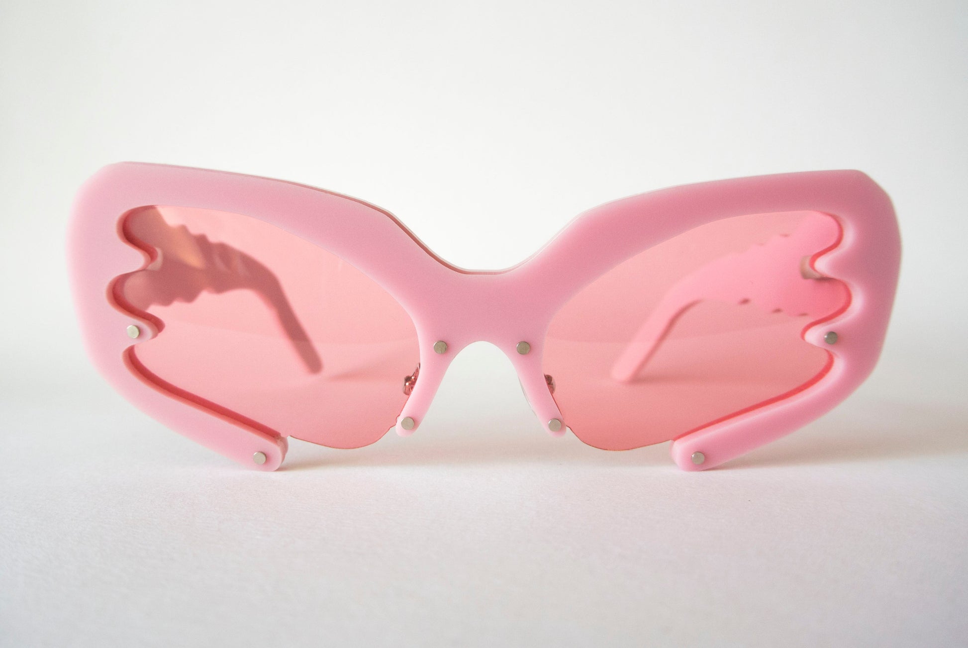 front view of pink 90s glasses with pink lenses by anna mulhearn