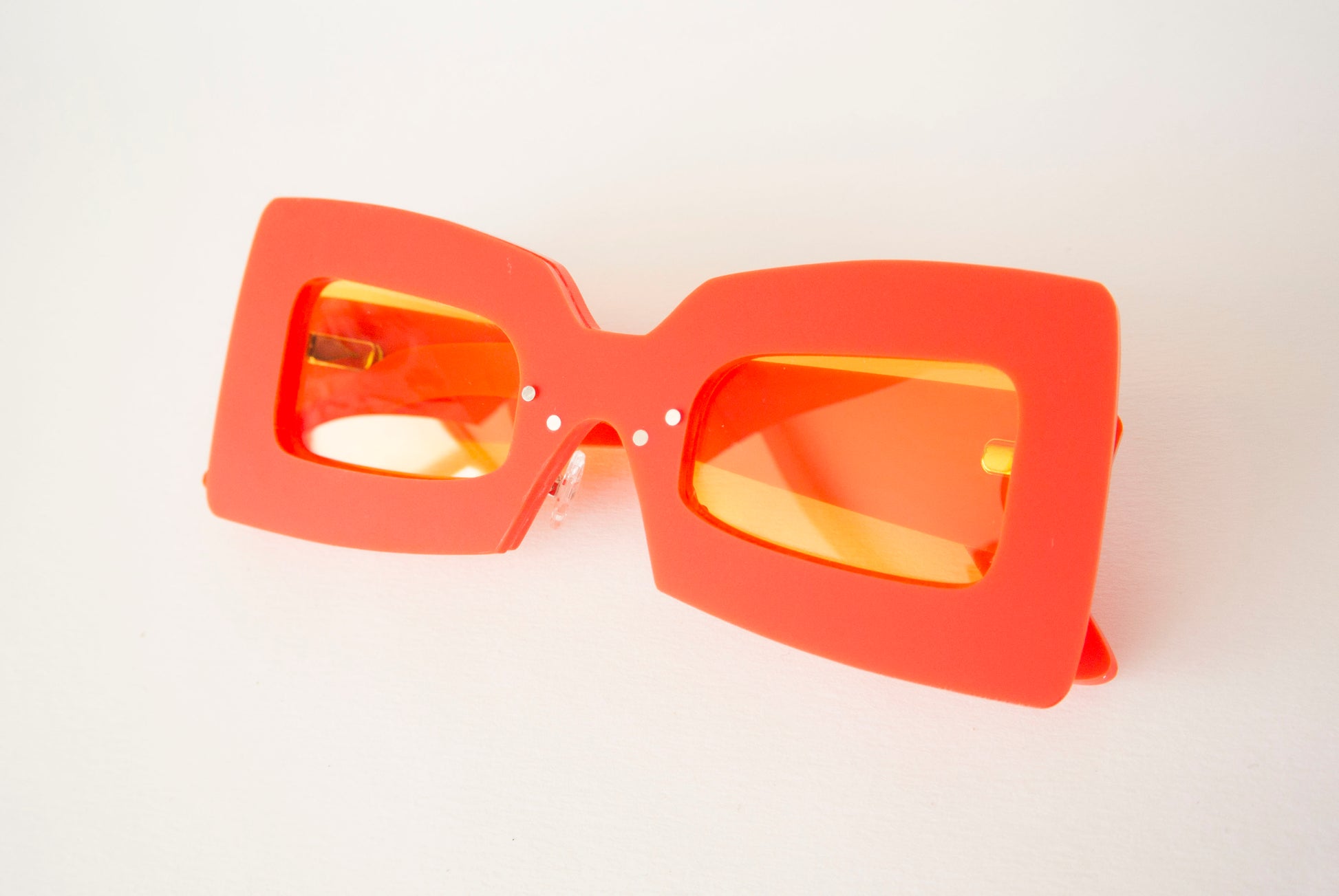 matte red glasses with yellow lenses