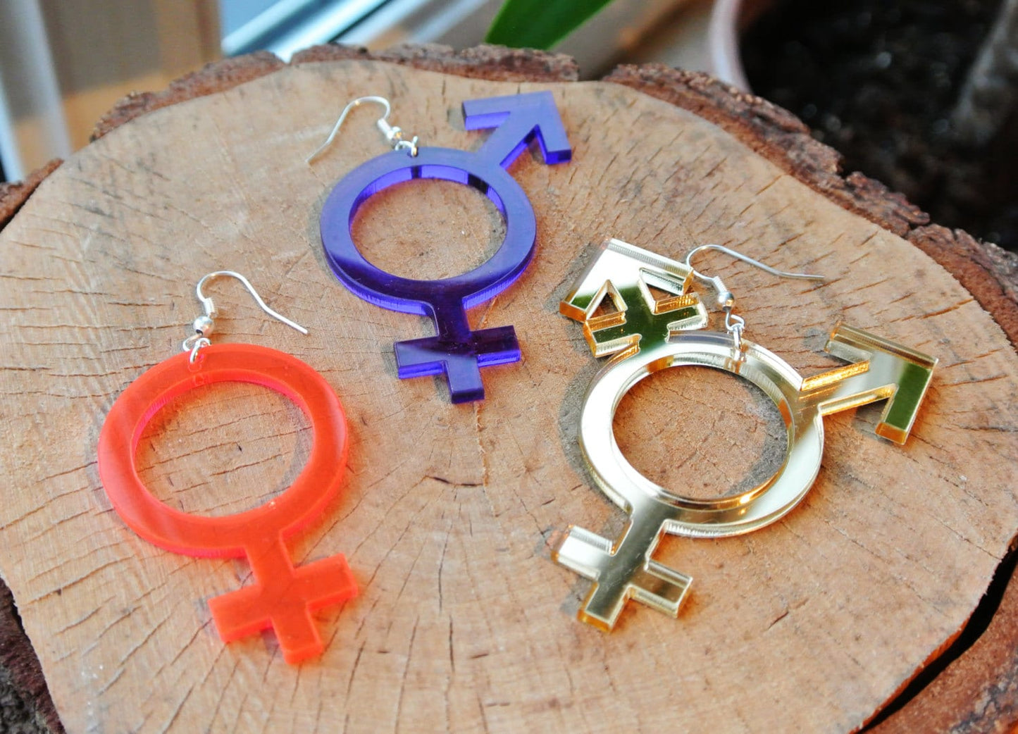 Neon orange female symbol earrings, purple bigender earrings and gold trans symbol earring by animalhair