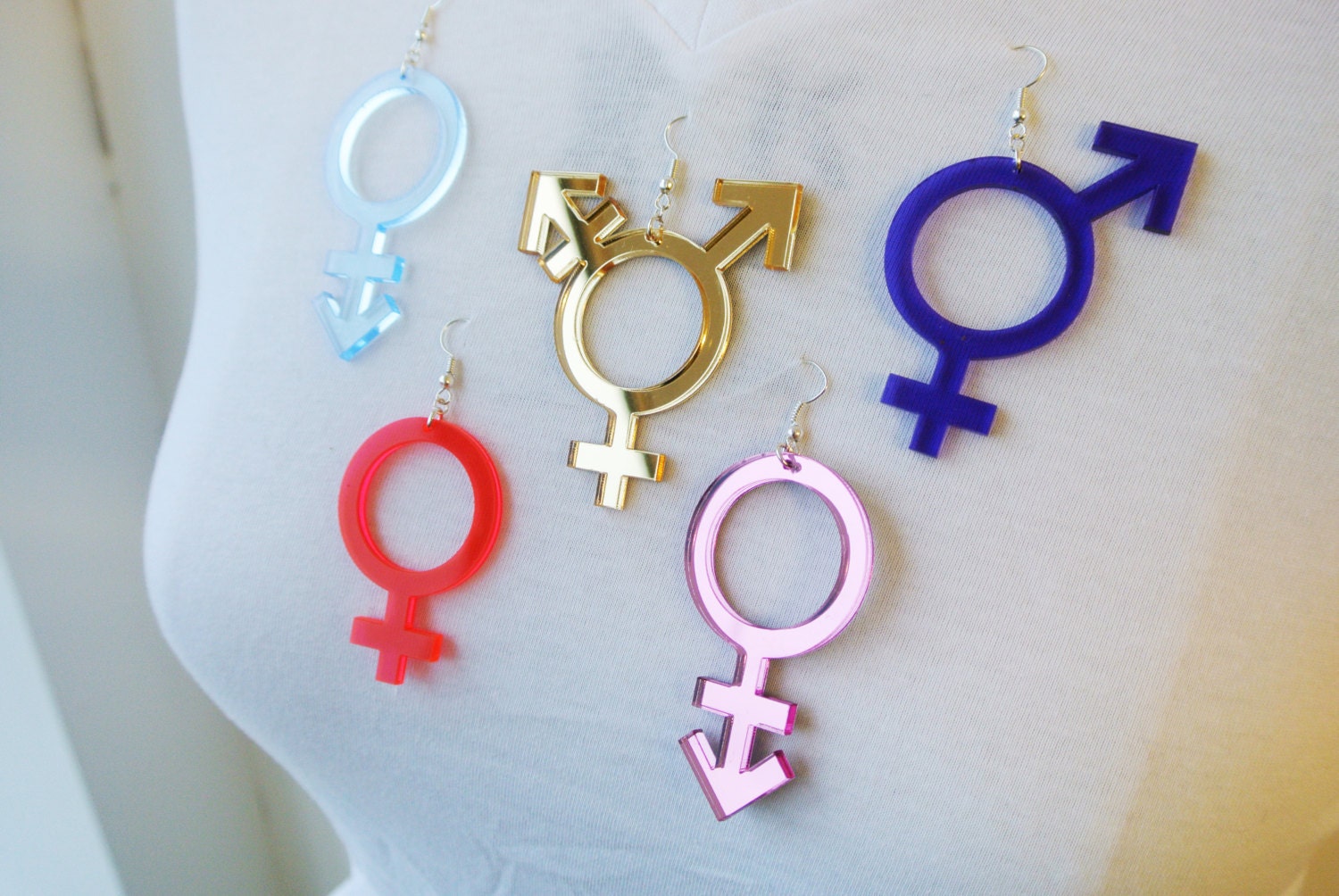 an androgynous, trans, bi-gender and female symbol selection of earrings by Anna mulhearn for animalhair.