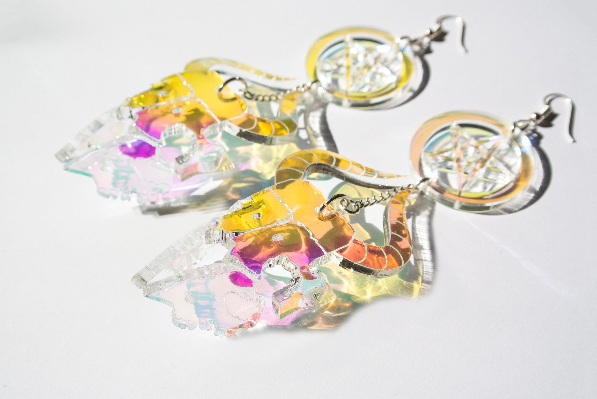 Iridescent goat skull earrings pair